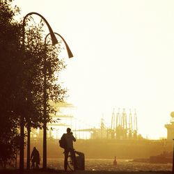 Silhouette of woman against clear sky at sunset