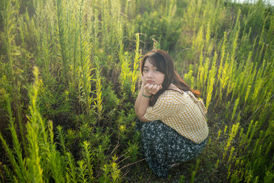 Woman standing on grass in field