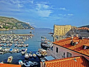 Boats in harbor with buildings in background