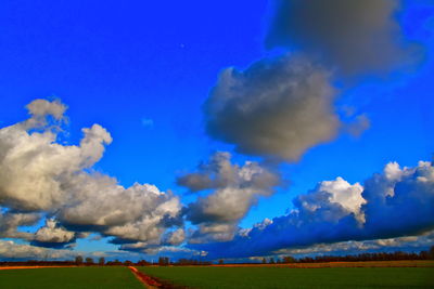 Panoramic view of landscape against blue sky