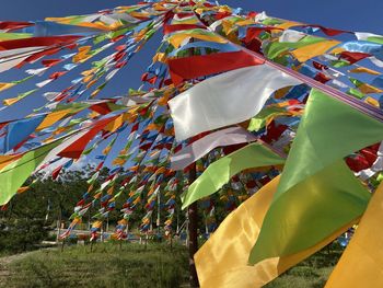Low angle view of flags hanging against sky