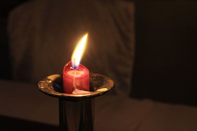 High angle view of illuminated candle in room