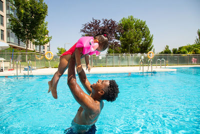 Rear view of woman swimming in pool