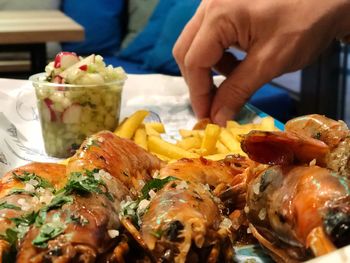 Close-up of hand holding food on table