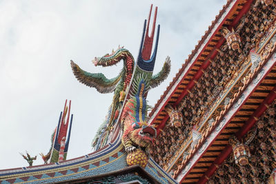 Low angle view of statue against temple building