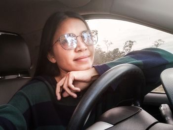Portrait of woman sitting in car