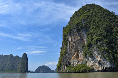 Rock formations by sea against sky