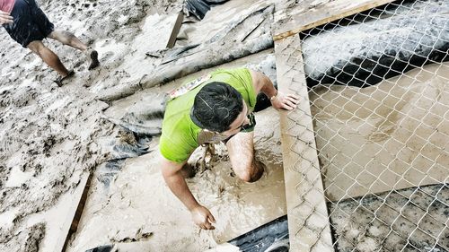 High angle view of man in mud