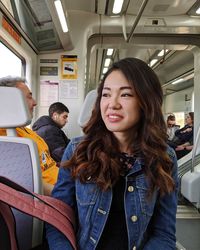 Portrait of smiling young woman in bus