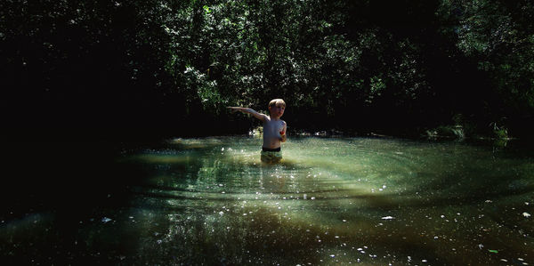 Full length of man standing in water