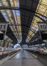 Trains on the platforms of a barcelona station with a fantastic roof