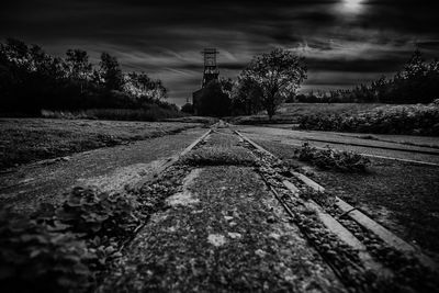 Surface level of railroad tracks against sky