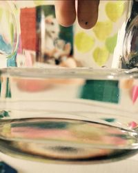 Close-up of man drinking water in glass