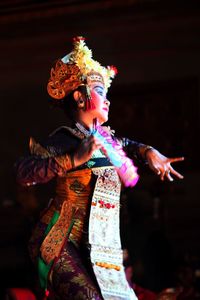 Young woman dancing in traditional clothing
