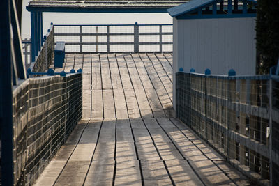 Empty footpath amidst buildings