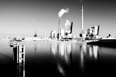 Commercial dock by sea against sky