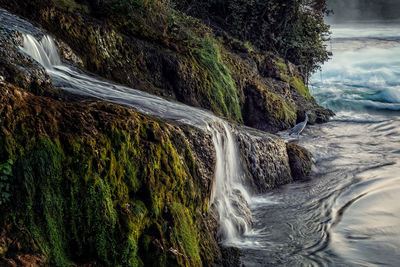 Long exposure photograph of the rhein falls with the laufen castle on the background.