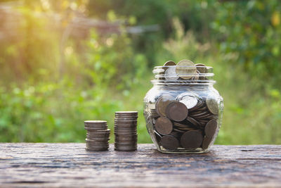 Close-up of coins in jar on table