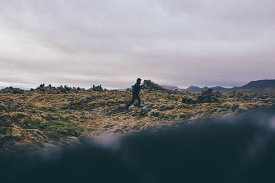 Scenic view of landscape against cloudy sky