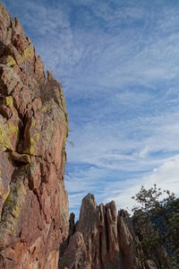 Low angle view of rock formations against sky