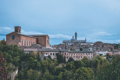 Buildings in city against sky