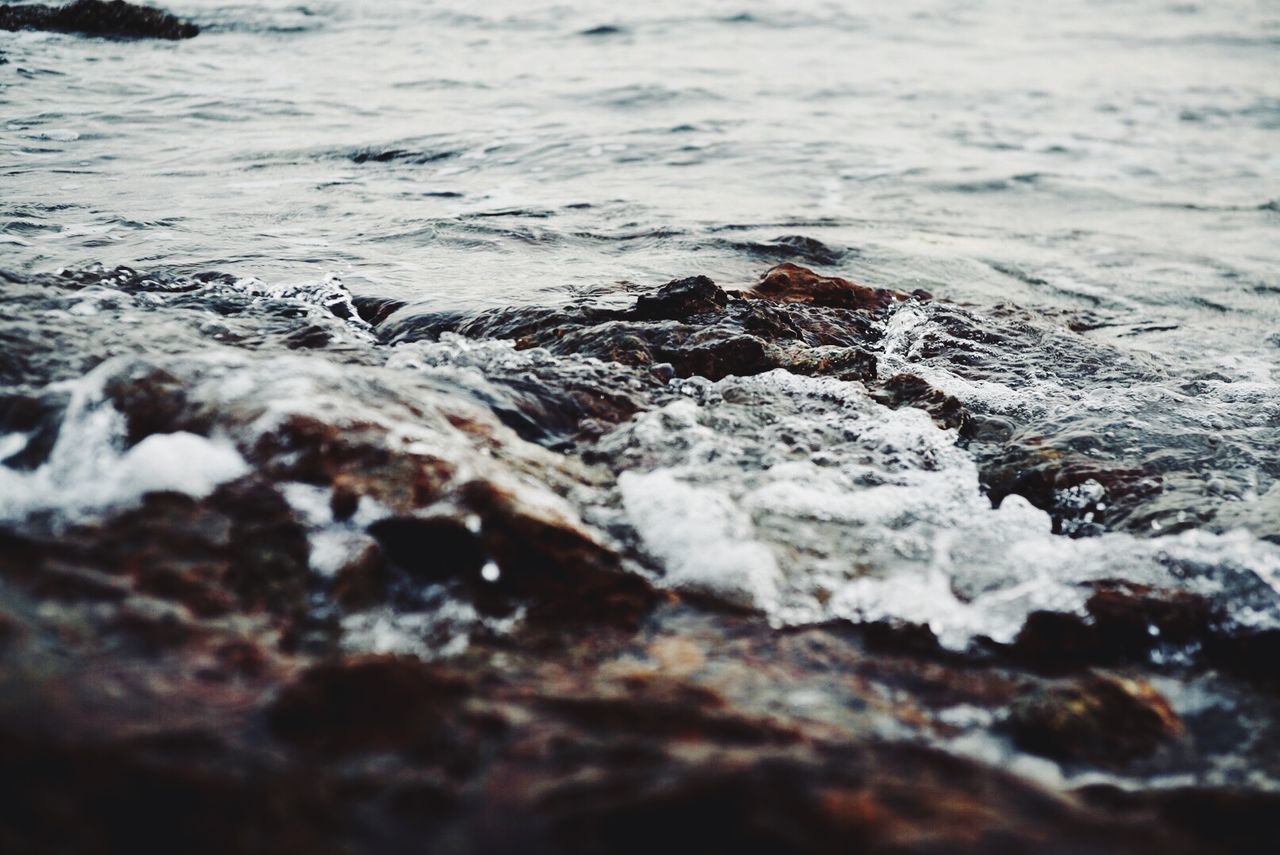 CLOSE-UP OF ROCKS ON SHORE