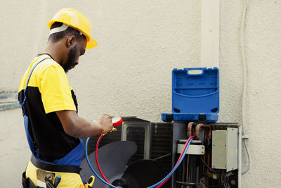 Side view of man working at construction site