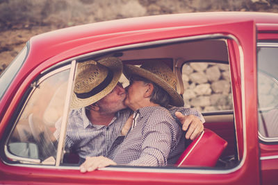 Senior couple kissing in car