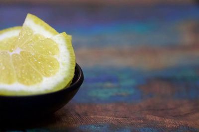 Close-up of lemon slices in bowl on table