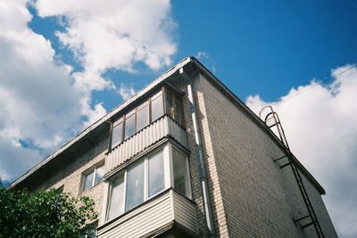 Low angle view of building against cloudy sky