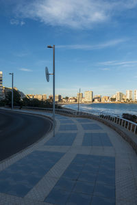 City street by buildings against sky