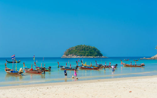 Scenic view of beach against clear blue sky