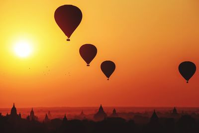 Silhouette of hot air balloons over bagan at sunrise in misty morning, myanmar