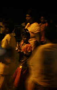 Blurred motion of people walking on road