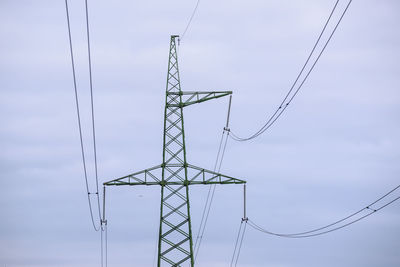 Low angle view of electricity pylon against sky