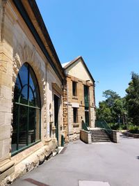 Low angle view of building against clear blue sky