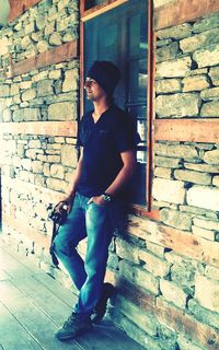 Full length of man standing on wall
