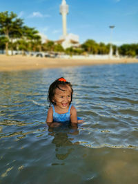 Portrait of cute baby girl in water