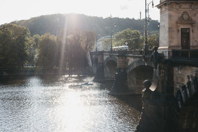 Arch bridge over river against sky