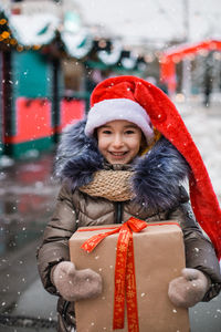 Portrait of smiling young woman in warm clothes