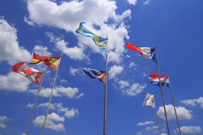 Low angle view of flags against sky