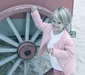 Portrait of a smiling girl against wheel