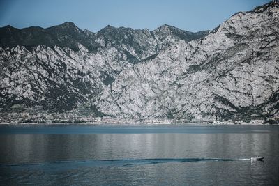 Scenic view of lake and mountains against clear sky