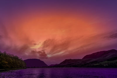 Scenic view of sea against romantic sky at sunset