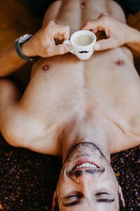 Midsection of man holding coffee cup