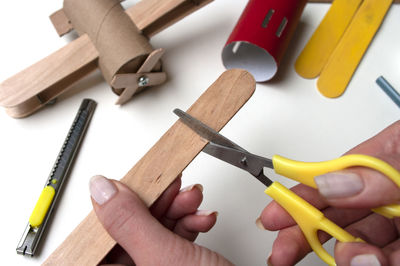 High angle view of hand holding tools on table
