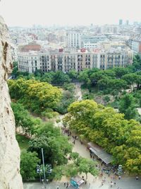 High angle view of trees and cityscape against sky