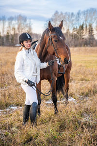 Side view of horse standing on field