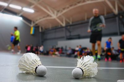 Full length of player standing on badminton court