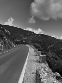 Road by mountain against sky